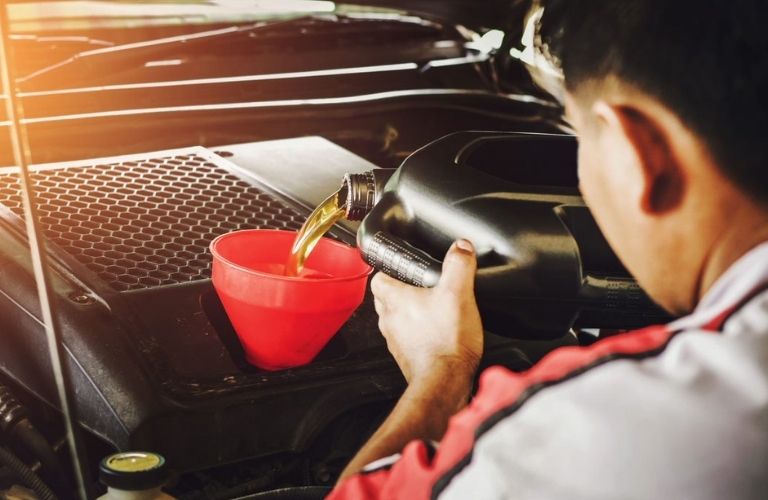 Mechanic changing the engine's oil